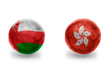 football balls with national flags of hong kong and oman ,soccer teams. on the white background.