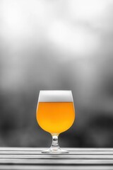 A glass of amber-colored craft beer on a wooden table