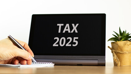 Planning tax 2025 new year symbol. Concept words Tax 2025 on beautiful black tablet. Beautiful white background. Businessman hand. Business tax 2025 new year concept. Copy space.