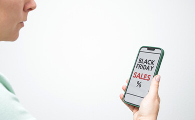 Close up of a female holding a smartphone with screen displaying a Black Friday online sale