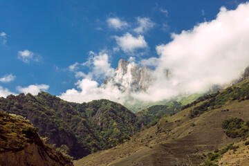 Mountains in the Caucasus, Russia. View on the hills and blue sky with white cottony clouds