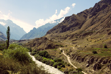 Extreme terrain, mountains and a mountain stream, blue sky.