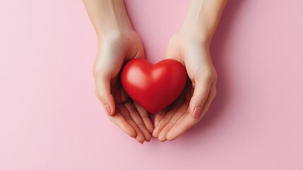 Obraz premium A touching image of a red heart in adult hands on a pink background, representing health care, organ donation, and family protection