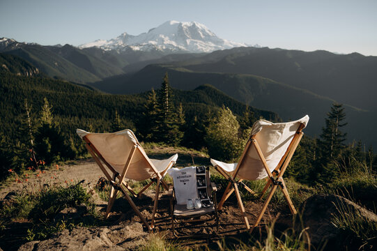 Panoramic mountain views with camping chairs for two people.