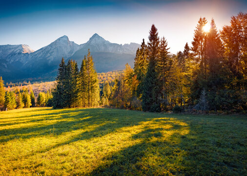 Colorful autumn sunset in High Tatras (Vysoke Tatry) mountains. Amazing evening view of two peaks - Zdiarska Vidla and Havran, slovakia, Europe. Beauty of nature concept background..