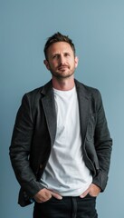 Fototapeta premium Innovative Tech Entrepreneur Portrait in Casual Blazer Against Light Blue Background