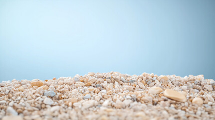 Pebble stones on light blue background, nature-inspired texture, calm and peaceful backdrop, minimalist natural setting