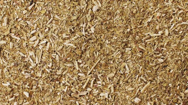 Mate tea latin american leaf Ilex paraguariensis in a brown ceramic bowl, dried spices