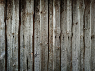 Vintage texture from dark wooden boards in row. Wooden fence made of boards