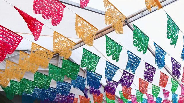 Colorful papel picado banners adorning a lively setting, honoring mexican customs with a festive flair