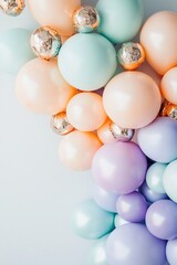 Pastel balloons with golden accents on light background.
