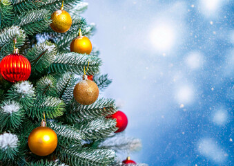 colourful Christmas decorations on a green Christmas tree with beautiful bokeh in the background