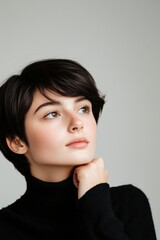 Thoughtful young woman with dark hair and blue eyes