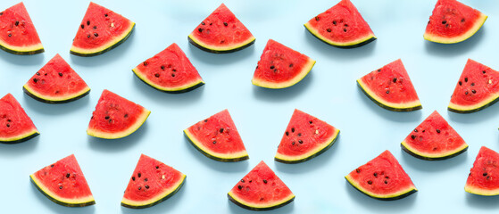 Pieces of fresh watermelon on blue background