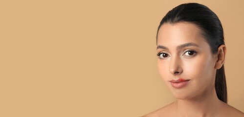Beautiful young woman with cold sore on beige background with space for text