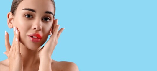 Young woman with cold sore on lip against light blue background with space for text