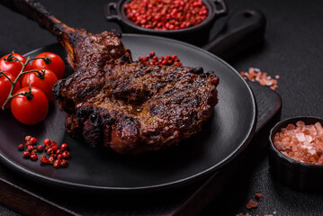 Grilled wagyu beef tomahawk steak with salt, spices and herbs