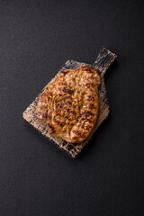 Grilled beef or pork steak with salt, spices and herbs