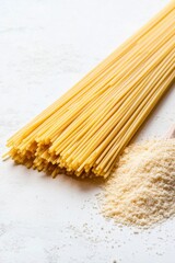 Closeup of uncooked spaghetti noodles on a white surface with breadcrumbs