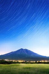 Fototapeta premium Stunning night sky with star trails over a majestic mountain landscape