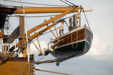 A vintage lifeboat, or dinghy, mounted on the back of a larger vessel, used for emergencies to allow crew and passengers to evacuate in case of an emergency at sea. Phuket, Thailand.