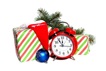 An alarm clock stands next to gift boxes for Christmas.