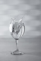 Glass with water up and splash. Healthy lifestyle concept