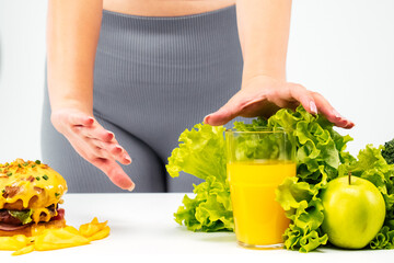 A young plump woman is choosing healthy and dietary food. Concept, diet, unhealthy food, low fat, for good health.