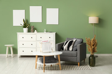 Chest of drawers, armchair and coffee table in interior of living room