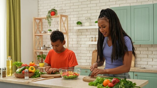 African American happy family preparing food in the kitchen.