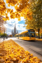 Obraz premium Vibrant autumn scene with a tram passing by a cathedral in a city