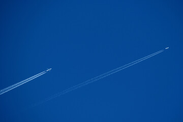 Airplane trails in the blue sky, contrails.