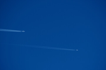 Airplane trails in the blue sky, contrails.