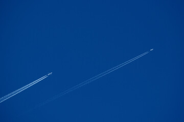 Airplane trails in the blue sky, contrails.