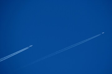 Airplane trails in the blue sky, contrails.