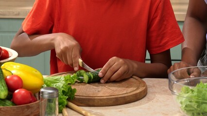 African American happy family preparing food in the kitchen.
