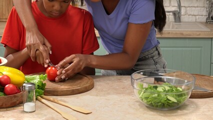 African American happy family preparing food in the kitchen.