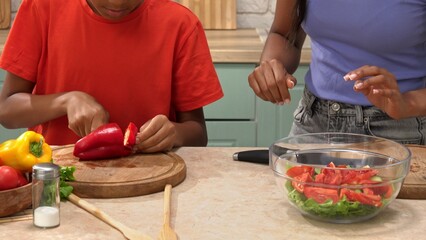 African American happy family preparing food in the kitchen.