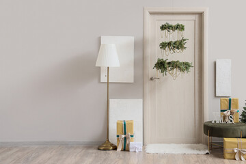 Door in decorated for Christmas room with gift boxes