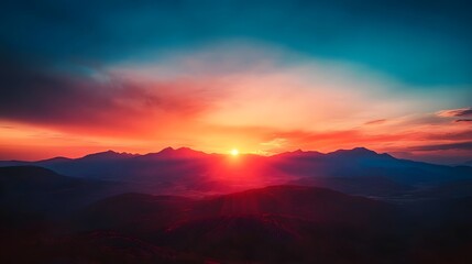 Fototapeta premium Sunrise over the mountains, with the early morning light illuminating the rugged peaks in a warm, golden glow