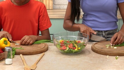African American happy family preparing food in the kitchen.