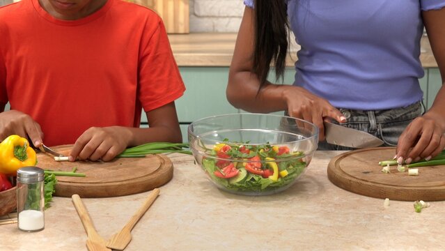 African American happy family preparing food in the kitchen. - Powered by Adobe