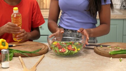 African American happy family preparing food in the kitchen.