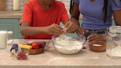 African American happy family preparing food in the kitchen.