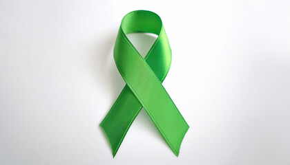 Green awareness ribbon on white backdrop. International symbol of mental health awareness.