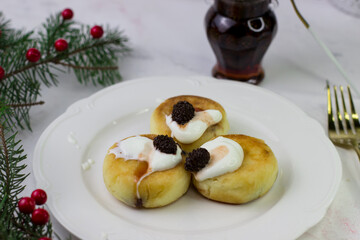 Apetite cheesecakes on a white plate. Christmas Breakfast