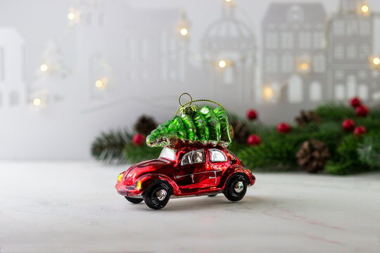 A toy in the shape of a red car with a Christmas tree on top. Christmas and New Year's Eve