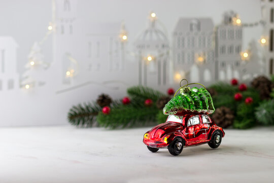 A toy in the shape of a red car with a Christmas tree on top. Christmas and New Year's Eve