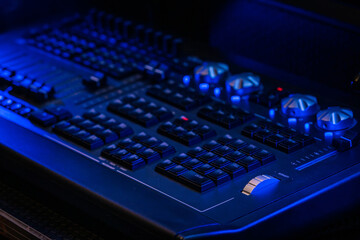 Close-up view of a digital audio mixing console featuring an interactive display and colorful LED-lit knobs. Ideal for sound engineering, music production, and live performance settings