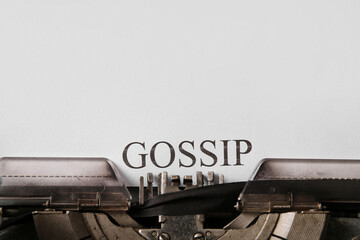 Typewriter and paper with word GOSSIP, closeup
